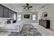 A view of a modern carpeted primary bedroom with a light grey rug, dark wood dresser, and recessed lighting at 11305 Knollwood Bend, Johns Creek, GA 30097