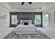 Stunning bedroom features a tray ceiling, decorative wall, two windows, and a large white bed on top of a blue rug at 11305 Knollwood Bend, Johns Creek, GA 30097