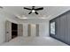 Spacious main bedroom with tray ceiling, accent wall, and neutral carpet at 11305 Knollwood Bend, Johns Creek, GA 30097