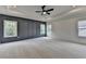Spacious main bedroom featuring a decorative ceiling and gray accent wall with bright windows at 11305 Knollwood Bend, Johns Creek, GA 30097