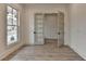 Bright office space with hardwood flooring, a large window, and double French doors providing a professional and inviting atmosphere at 11305 Knollwood Bend, Johns Creek, GA 30097