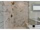 The luxurious marble shower is encased in glass and has a comfortable bench for a spa-like experience at 11305 Knollwood Bend, Johns Creek, GA 30097
