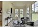 Cozy sitting area with armchairs, modern decor, and views of the landscaped front yard at 11305 Knollwood Bend, Johns Creek, GA 30097