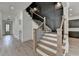 Elegant staircase with wood treads, black metal railings and stylish gray wall paneling detail at 11305 Knollwood Bend, Johns Creek, GA 30097