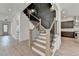 Elegant staircase with wood treads, black iron railings, and an accent wall paneling at 11305 Knollwood Bend, Johns Creek, GA 30097