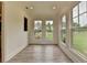 Bright sunroom with hardwood flooring and many large windows overlooking a beautiful backyard at 11305 Knollwood Bend, Johns Creek, GA 30097