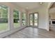 Bright sunroom features large windows, deck access, and durable wood-look floors at 11305 Knollwood Bend, Johns Creek, GA 30097