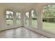 Sunroom featuring floor to ceiling window, bright light and views of the professionally landscaped yard at 11305 Knollwood Bend, Johns Creek, GA 30097