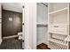 Bathroom showcasing tiled walk-in shower and an open closet with white shelving at 2195 Penelope Nw St, Atlanta, GA 30314
