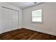 Bedroom with hardwood floors, window with blinds, and a standard closet at 2195 Penelope Nw St, Atlanta, GA 30314