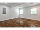 Minimalist bedroom featuring hardwood floors, two windows, and simple white walls at 2195 Penelope Nw St, Atlanta, GA 30314