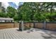 Well-maintained deck with gray railings and partial privacy fence, surrounded by trees at 2195 Penelope Nw St, Atlanta, GA 30314