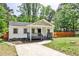 Inviting home with a well-maintained lawn, mature trees, and a charming covered porch at 2195 Penelope Nw St, Atlanta, GA 30314