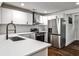Bright kitchen features white cabinets, stainless steel appliances, and stylish fixtures at 2195 Penelope Nw St, Atlanta, GA 30314