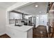 Modern kitchen with white cabinets, quartz countertops, and stainless-steel appliances, and rustic barn door at 2195 Penelope Nw St, Atlanta, GA 30314