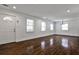 Spacious living room with hardwood floors, neutral walls, many windows, and modern lighting at 2195 Penelope Nw St, Atlanta, GA 30314