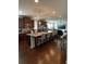 Spacious kitchen featuring a large granite island with seating, stainless steel appliances, and hardwood floors at 292 Aylesbury Blvd, Mcdonough, GA 30252