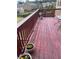 Spacious wooden deck with a red stain, surrounded by a wooden railing and planters at 292 Aylesbury Bv, Mcdonough, GA 30252