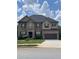 Charming two-story home with a well-manicured lawn, stone and brick facade and a two car garage at 292 Aylesbury Bv, Mcdonough, GA 30252