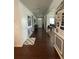 Inviting hallway featuring hardwood floors, decorative wainscoting, and a view of the home's entryway at 292 Aylesbury Bv, Mcdonough, GA 30252