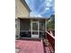 Exterior view of screened patio with ceiling fan and outdoor furniture. Deck leads to outdoor spaces at 292 Aylesbury Bv, Mcdonough, GA 30252