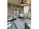 Relaxing screened-in patio featuring a ceiling fan, comfortable seating, and stylish outdoor rug at 292 Aylesbury Bv, Mcdonough, GA 30252