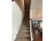 Carpeted stairway leading to the second floor, with a view of the kitchen and dining area below at 292 Aylesbury Bv, Mcdonough, GA 30252