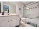 Bathroom featuring a shower and tub combination with a sliding glass door, a toilet, and a vanity with white cabinets at 1025 Ector Nw Dr, Kennesaw, GA 30152