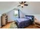 Attic bedroom featuring a bed with galaxy patterned sheets, hardwood floors, and a window with a view at 1025 Ector Nw Dr, Kennesaw, GA 30152