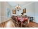 Bright dining room features hardwood floors, large window, and elegant chandelier at 1025 Ector Nw Dr, Kennesaw, GA 30152