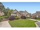 Charming home featuring stone and shingle accents, lush landscaping, and a curved driveway on a well-maintained lawn at 1025 Ector Nw Dr, Kennesaw, GA 30152