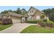 Beautiful stone and shingle home with a manicured lawn and a curved driveway leading to an attached garage at 1025 Ector Nw Dr, Kennesaw, GA 30152