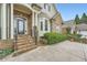 Inviting front entrance with stone steps, arched doorway, and manicured landscaping showcasing the home's curb appeal at 1025 Ector Nw Dr, Kennesaw, GA 30152