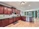 Well-appointed kitchen featuring granite countertops, stainless steel appliances, and ample cabinet space with hardwood floors at 1025 Ector Nw Dr, Kennesaw, GA 30152