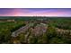 An expansive aerial view of a townhome community with trees and distant city skyline at 2066 Patterson Park Rd, Decatur, GA 30033