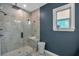 Modern walk-in shower, featuring sleek fixtures and a seating bench inside the glass enclosure at 2066 Patterson Park Rd, Decatur, GA 30033