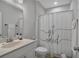 Bright bathroom with a single sink vanity, toilet, and a playful shower curtain at 2066 Patterson Park Rd, Decatur, GA 30033