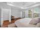 Spacious bedroom featuring a tray ceiling, modern ceiling fan, and natural light from large windows at 2066 Patterson Park Rd, Decatur, GA 30033