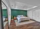 Bright bedroom featuring tray ceiling, modern ceiling fan, and a stylish accent wall at 2066 Patterson Park Rd, Decatur, GA 30033
