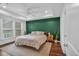 Inviting bedroom featuring a modern ceiling fan, and a stylish accent wall at 2066 Patterson Park Rd, Decatur, GA 30033