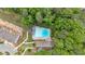 Aerial view of a community pool area surrounded by lush greenery and lounge chairs at 2066 Patterson Park Rd, Decatur, GA 30033