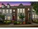 Charming townhouse exterior with brick accents, illuminated landscaping, and inviting entryways at 2066 Patterson Park Rd, Decatur, GA 30033