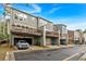 View of townhomes with gray siding, decks, and garages on a sunny day at 2066 Patterson Park Rd, Decatur, GA 30033