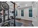 Well-lit home gym features a squat rack, treadmill and ample natural light from three large windows at 2066 Patterson Park Rd, Decatur, GA 30033