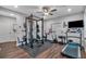 Spacious home gym with modern equipment, including a squat rack, treadmill, and weight bench on padded flooring at 2066 Patterson Park Rd, Decatur, GA 30033