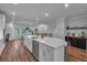 Open concept kitchen features a large island, stainless steel appliances, and a wine bar at 2066 Patterson Park Rd, Decatur, GA 30033