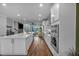 Modern kitchen features sleek white cabinets, a large island, and open layout to living area at 2066 Patterson Park Rd, Decatur, GA 30033