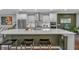 Modern kitchen boasts white cabinets, stainless steel appliances, and a large island with seating at 2066 Patterson Park Rd, Decatur, GA 30033