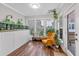 Bright sunroom features hardwood floors, lots of windows, and lush greenery at 2066 Patterson Park Rd, Decatur, GA 30033