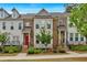 Charming brick townhouse with landscaped front yard, colorful door, and inviting curb appeal at 2066 Patterson Park Rd, Decatur, GA 30033